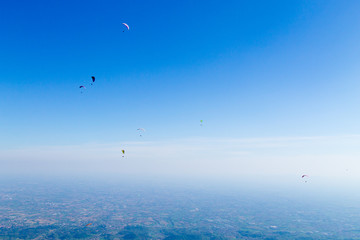 Paraglider on blue sky, Borso del Grappa, Italy