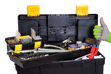 Tool box isolated. Black plastic tool kit box with assorted tools and a glove showing the thumb up sign for good work isolated on a white background.