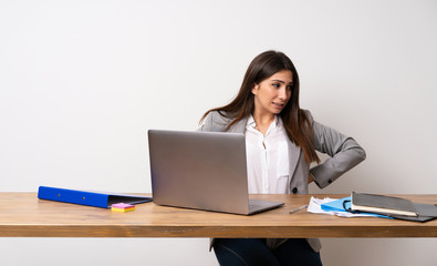 Business woman in a office suffering from backache for having made an effort