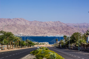 south Middle East city view park outdoor district car road down to Gulf of Aqaba Red sea bay, palm...