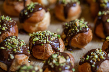 Profiteroles coated with chocolate and nuts