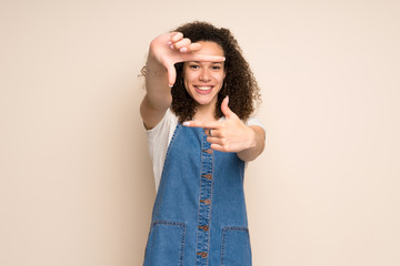 Dominican woman with overalls focusing face. Framing symbol