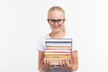 education, people, children and school concept - School student in goggles holding books in hands on white background