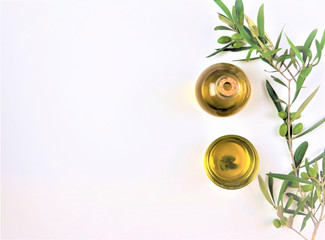 olive oil with a branch of green olives on white background