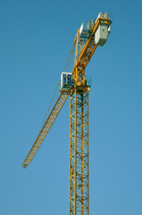 lifting tower crane against the blue sky.