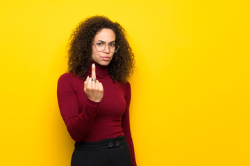 Dominican woman with turtleneck sweater making horn gesture