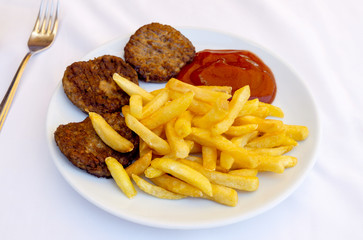 Meat BBQ cutlet with french fries and ketchup on white plate