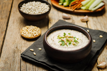 White bean hummus on a wood background
