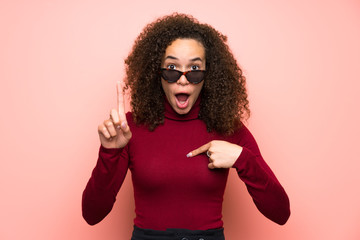 Dominican woman with turtleneck sweater with surprise facial expression