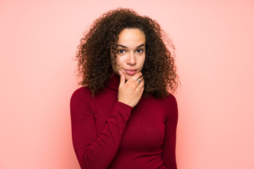 Dominican woman with turtleneck sweater thinking an idea