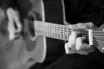 Close up photo of guitar player. Black and white photo