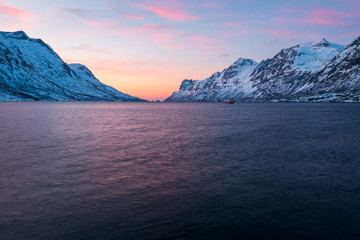 Fototapeta na wymiar Beautiful and colorful sunset in winter at Ersfjord, Norway