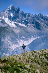 A trail runner, running along a trail in the high alpine mountains of the Mont Blanc range in France - 265012885