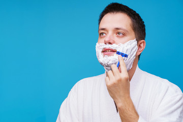 Image of man in white coat shaving