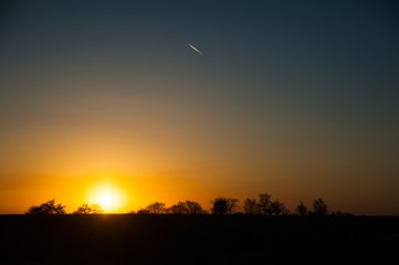 Natural sunset sunrise over field or meadow