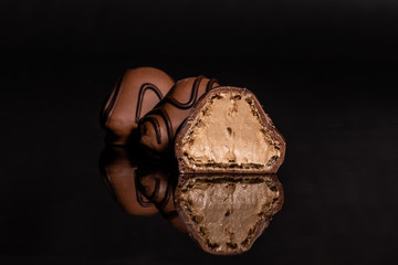Chocolate on glass with reflection. It can be used as a background