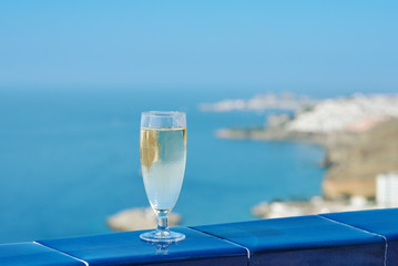 The glass of wine against the picturesque sea view illustrating the holiday and relax atmosphere.
