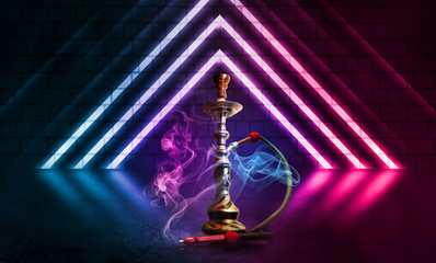 Hookah smoke on a dark abstract background. Background of empty scenes with multicolored neon lights, brick wall, reflection of night lights on wet asphalt