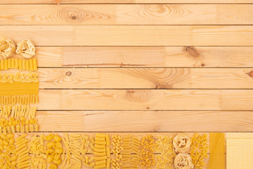 Wood natural panel with a lot of kind of pasta making the corner. Horizontal wooden slats as background