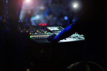 Fototapeta na wymiar DJ console at a party in the club, the work of a sound engineer