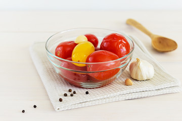 Marinated tomatoes in a glass bowl on the table. Fermented food close up