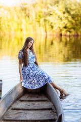 Lifestyle portrait of young beautiful woman sitting at motorboat. girl having fun at boat on the water.