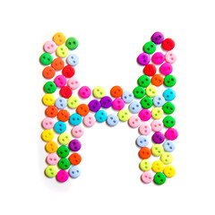 Letter H of the English alphabet made of multi-colored buttons