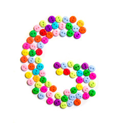 Letter G of the English alphabet made of multi-colored buttons