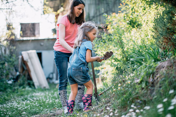 Mother and daughter working in the garden