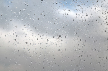 Raindrops on a window pane on a rainy day, texture background