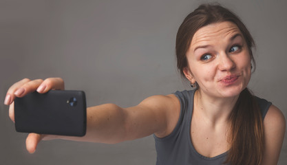 Selfie mania. Portrait of charming beautiful and exciting woman taking self portrait photo using...