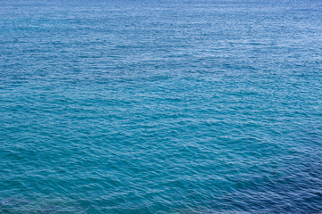 vivid blue water natural surface with ripple from small waves perspective background pattern