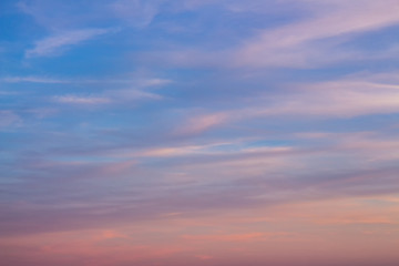 Naklejka na ściany i meble Bright orange sky at sunset. Pink clouds in the sun at dawn.