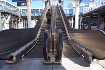 Old man in black outfit using escalator in airport © Kiryl Lis