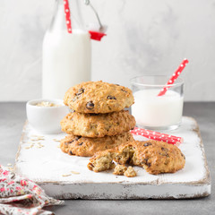 Homemade oatmeal cookies with chocolate and banana, milk in a glass with a tube. Delicious dessert, Breakfast (lunch), healthy food, pastries for children
