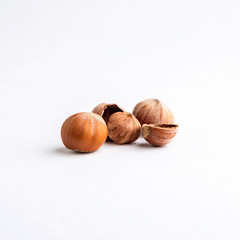 chopped hazelnuts, a pair of nuts lying side by side, on a white background, short focus