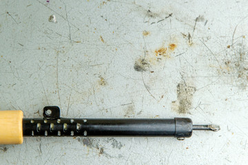 soldering iron on a metal board for soldering, traces of rosin and solder, scratches, burns