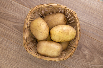 Plakat veganism: a few eco potatoes in a wicker basket