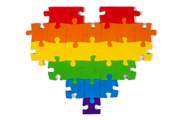 LGBT concept: gay flag of multi-colored puzzle in heart shape on white