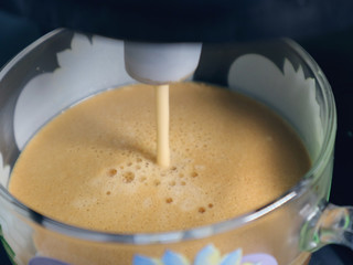 Fragrant coffee is poured from the nozzle of the coffee maker