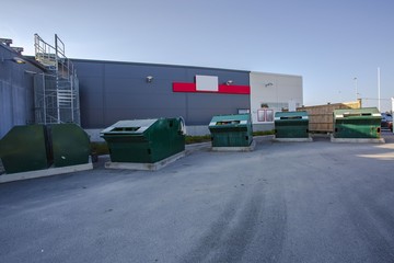 View of backside area of local store with containers for different kind of garbage. Environment concept.