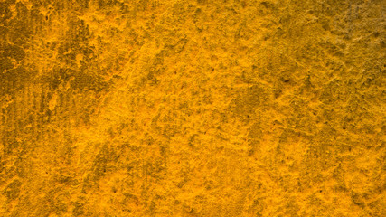 Golden stone surface texture. Natural background in gold color. Texture of stone wall in retro style. Widescreen