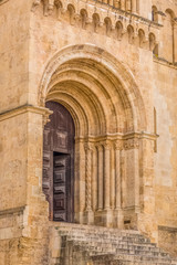 Fototapeta na wymiar Detailed view of frontal gate of the gothic building of Coimbra Cathedral