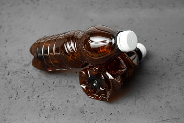 A plastic bottles on a stone countertop background. Concept of caring for the environment, recycling. Secondary plastic circuit. Environment pollution.