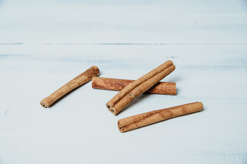Whole cinnamon on a wooden clear table. The concept of using seasonings for dishes. Strengthening the taste through spices, better cooking and better taste of dishes.
