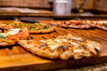 Authentic Italian pizza in a restaurant display window in Rome
