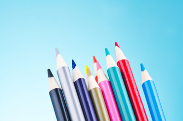 close-up image of colourful pencils over beautiful reverberation gradient background