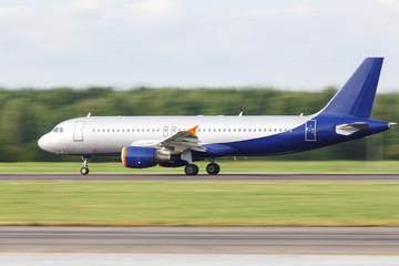 Narrow-body passenger airplane taxing on runway for take off, side view, in motion. Vacation,...
