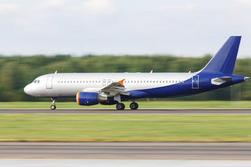 Fototapeta na wymiar Narrow-body passenger airplane taxing on runway for take off, side view, in motion. Vacation, aviation, travel, trip concept. Departure board