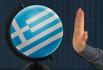 gesture of a male hand warns against the globe, which depicts a colored national state flag Greece